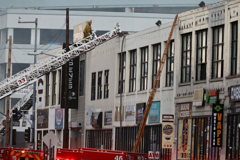 Firefighters battle a fire at the scene of a commercial fire at 327 E. Boyd St. downtown that has injured about 10 firefighters and left multiple buildings on fire.