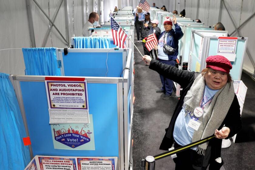 Marissa Mendoza directs a voter to an open voting machine as voters cast their ballots in an event tent at Arroyo Market Square on the last day of early voting Friday, Nov. 4, 2022. Election Day Tuesday, Nov. 8. (K.M. Cannon/Las Vegas Review-Journal) @KMCannonPhoto