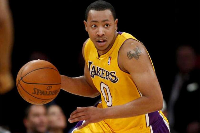 Lakers guard Andrew Goudelock brings the ball up the court during a game against the Charlotte Bobcats in 2012.