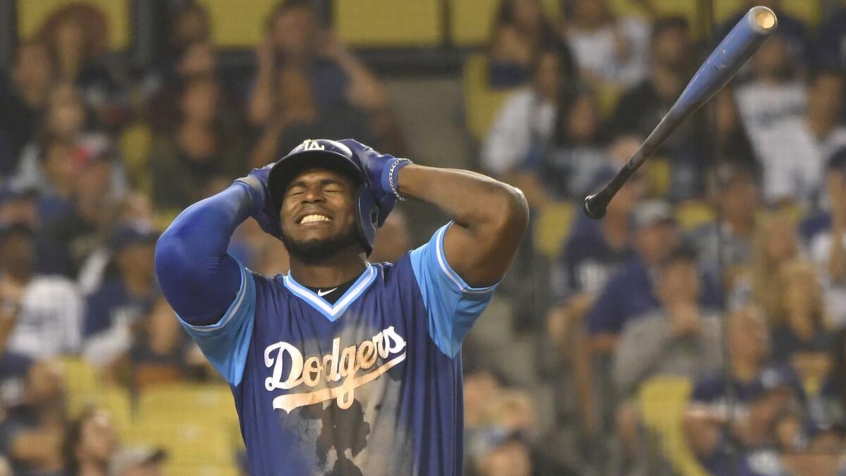 Dodgers outfielder Yasiel Puig reacts to hitting a pop-up in the eighth inning against San Diego on Aug. 25.