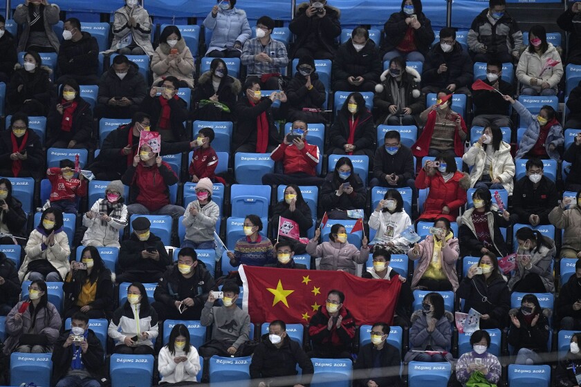 Fans cheer for Jin Boyang, of China, in the men's free skate program during the figure skating event.