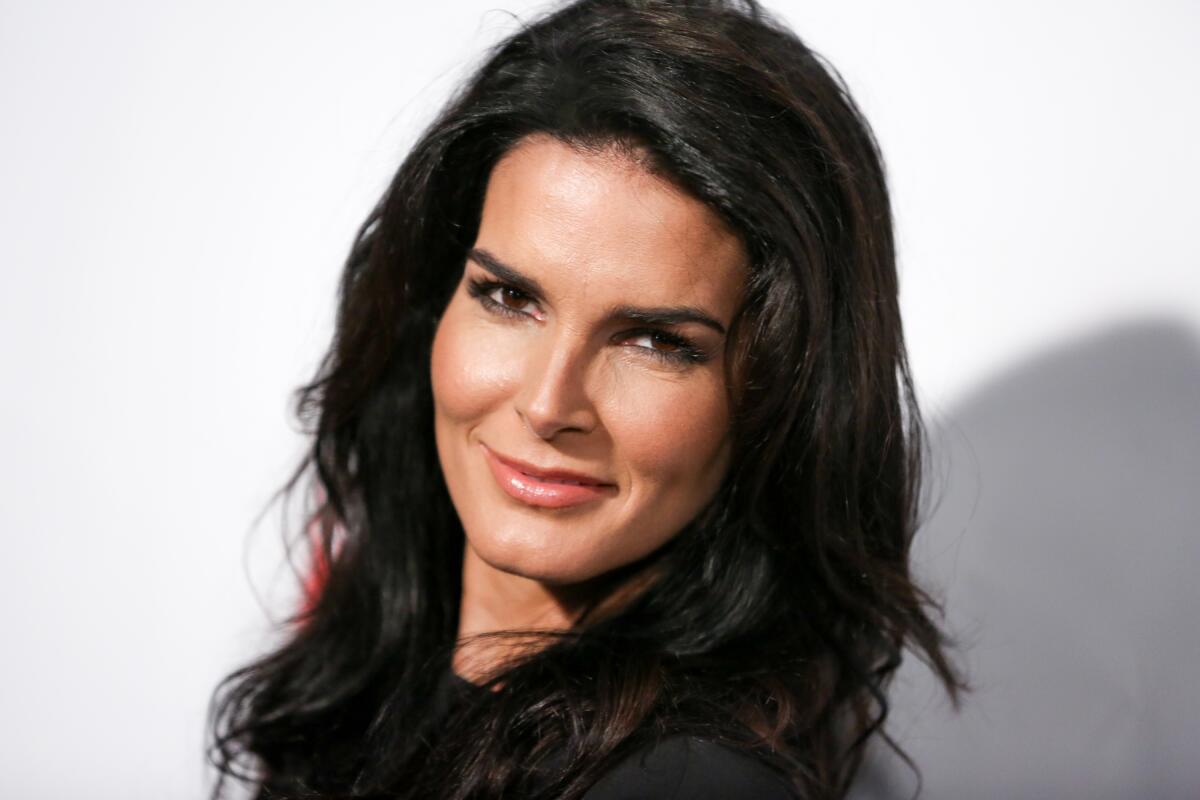 Angie Harmon smiling while looking slightly over her left shoulder