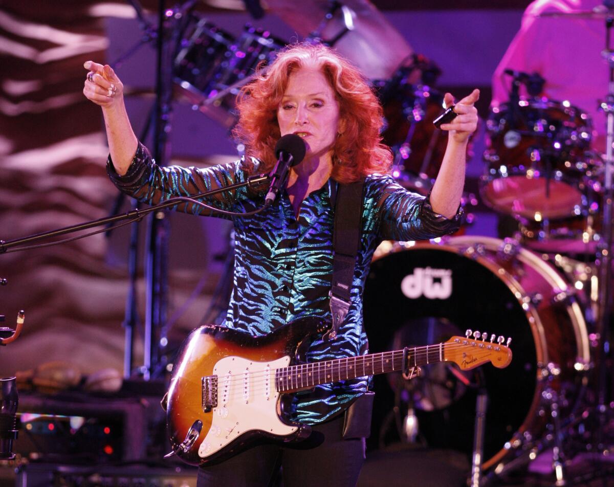 Bonnie Raitt, seen performing at the Greek Theatre on Sept. 22, 2012, will headline the Americana Music Assn.'s pre-Grammy concert tribute to Eagles founding member Glenn Frey on Feb. 13 at the Troubadour in West Hollywood.