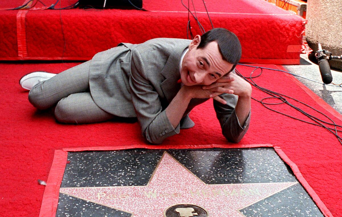Comedian Pee Wee Herman, actor Paul Reubens, admires his star on the Walk of Fame in Hollywood. Reubens will be hosting a 35th anniversary screening of the film “Pee-wee’s Big Adventure” at the Spreckels Theatre on Feb. 29.