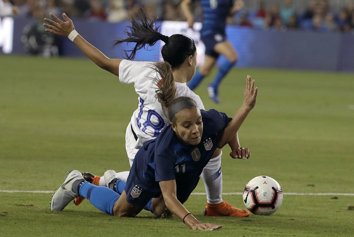 United States' Mallory Pugh, bottom, gets tangled up with Chile's Camila Saez during the first half of an international friendly soccer match in San Jose, Calif., Tuesday, Sept. 4, 2018. (AP Photo/Jeff Chiu)