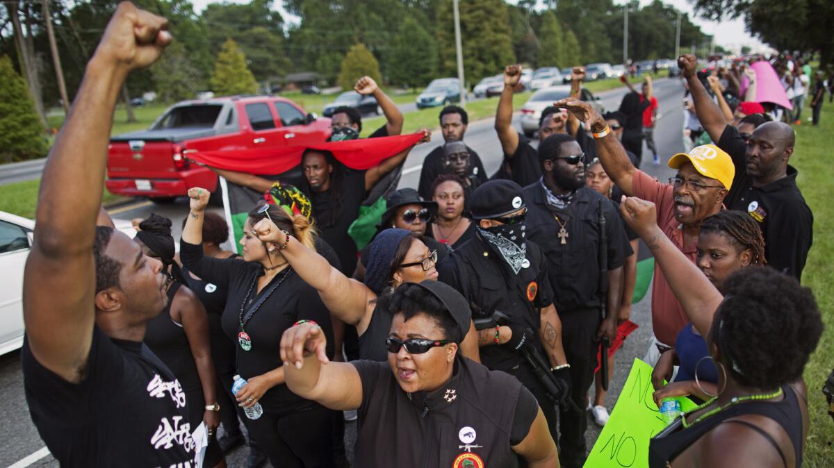 Members of the New Black Panther Party march in Louisiana following the death there of Alton Sterling. (Max Becherer / AP)