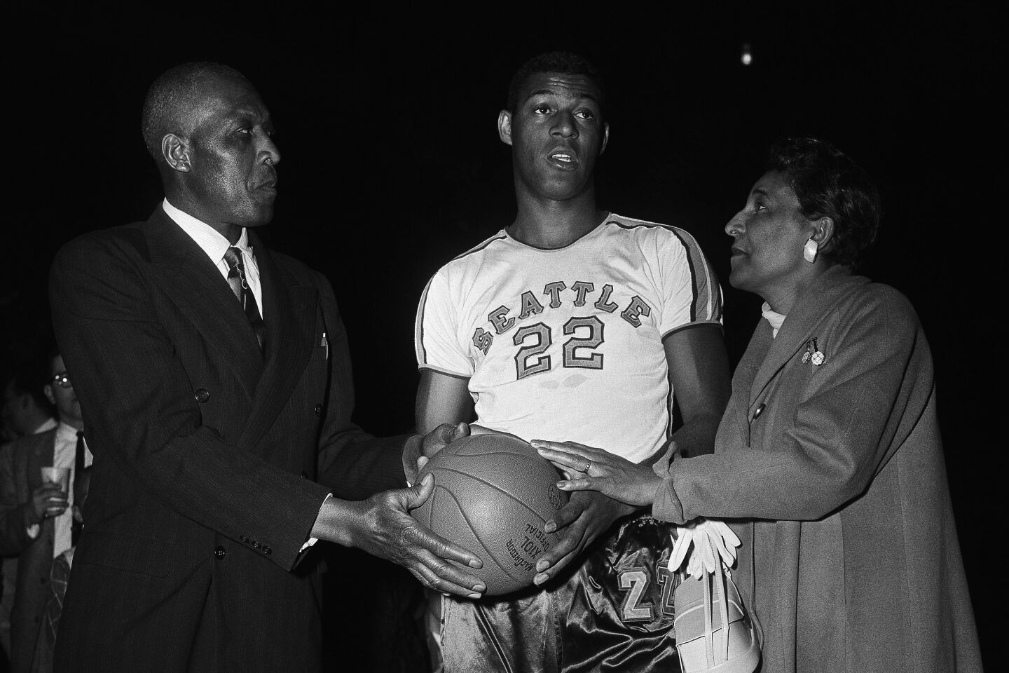 Mr. and Mrs. John W. Baylor with their son Elgin as he gets ready to play for the Seattle University team in the National Invitation Tournament in Madison Square Garden in New York on March 18, 1957.