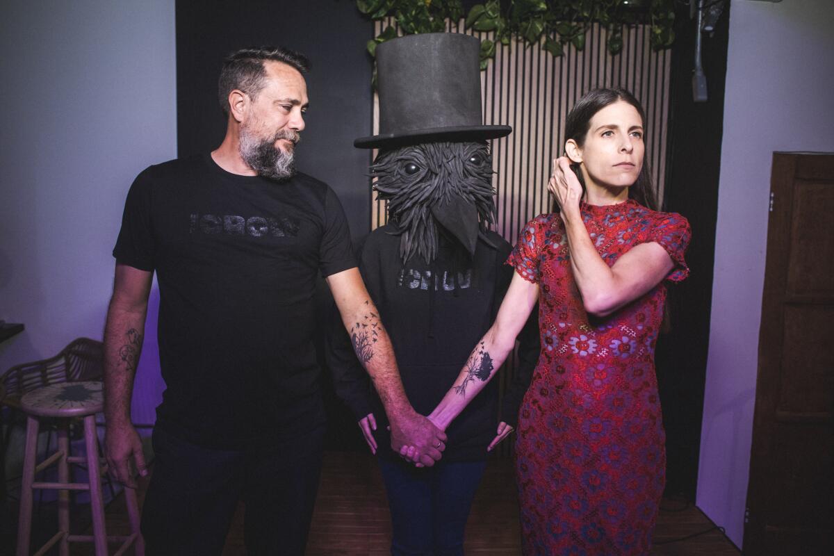 Man and woman holding hands inside a comedy club