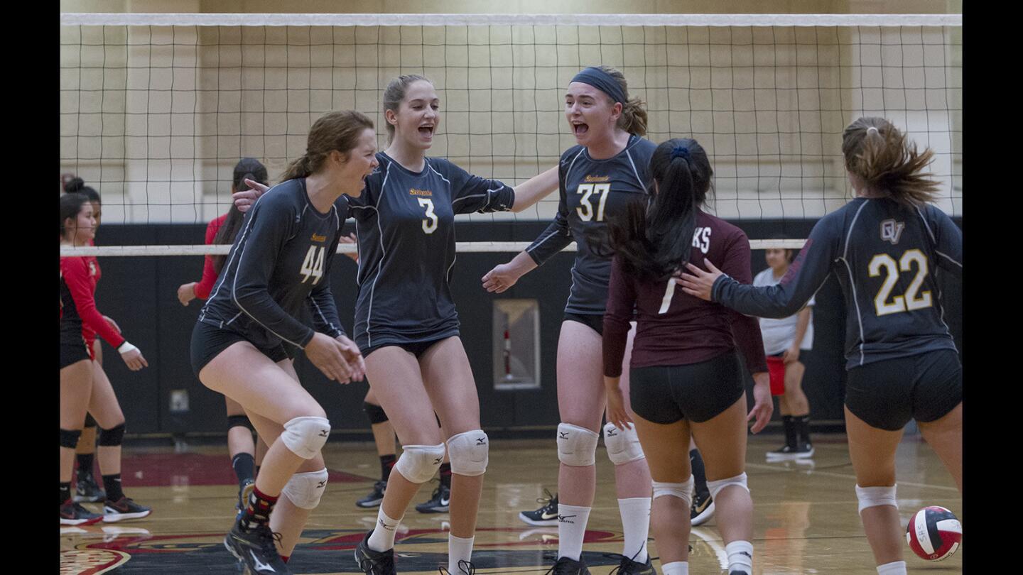 Ocean View High players celebrate beating Segerstrom, 31-29, in the first set during a Golden West League match in Santa Ana on Thursday, Sept. 21.