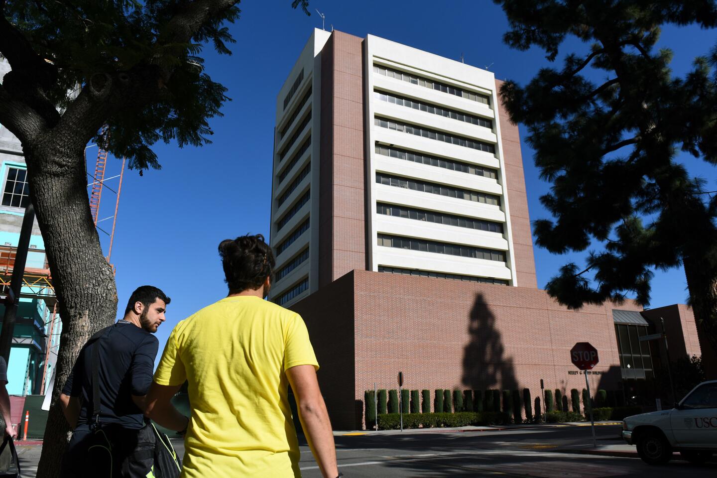 People walk by the Seeley G. Mudd building Saturday on the USC campus where USC psychology professor Bosco Tjan was stabbed to death Friday night.