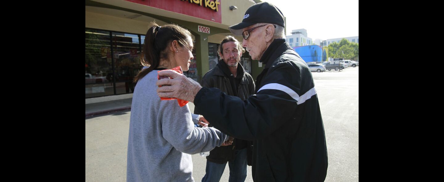 Dave Ross, right says goodbye to Katarina Boudreau and Gary Arnold, who are new to being homeless, after Ross gave them water and snacks.