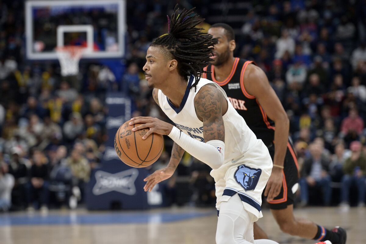 Memphis Grizzlies guard Ja Morant (12) drives with the ball in the second half of an NBA basketball game against the New York Knicks, Friday, March 11, 2022, in Memphis, Tenn. (AP Photo/Brandon Dill)