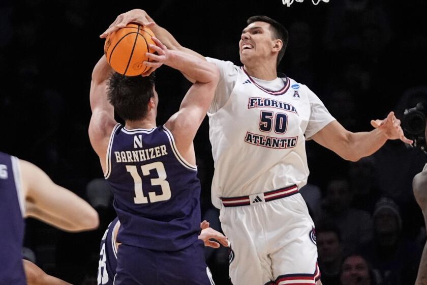 FILE - Florida Atlantic's Vladislav Goldin (50) blocks a shot by Northwestern's Brooks Barnhizer (13) during the first half of a first-round college basketball game in the NCAA Tournament, Friday, March 22, 2024, in New York. Vladislav Goldin has withdrawn from the NBA draft and will join his coach from Florida Atlantic, Dusty May, as a graduate transfer at Michigan. Goldin’s decision was first reported Monday, April 29, 2024, by ESPN on X, formerly Twitter. (AP Photo/Frank Franklin II, File)