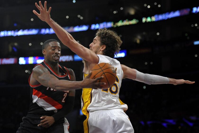 Portland Trail Blazers guard Wesley Matthews, left, passes behind Lakers forward Pau Gasol during the first half of Sunday's game at Staples Center.