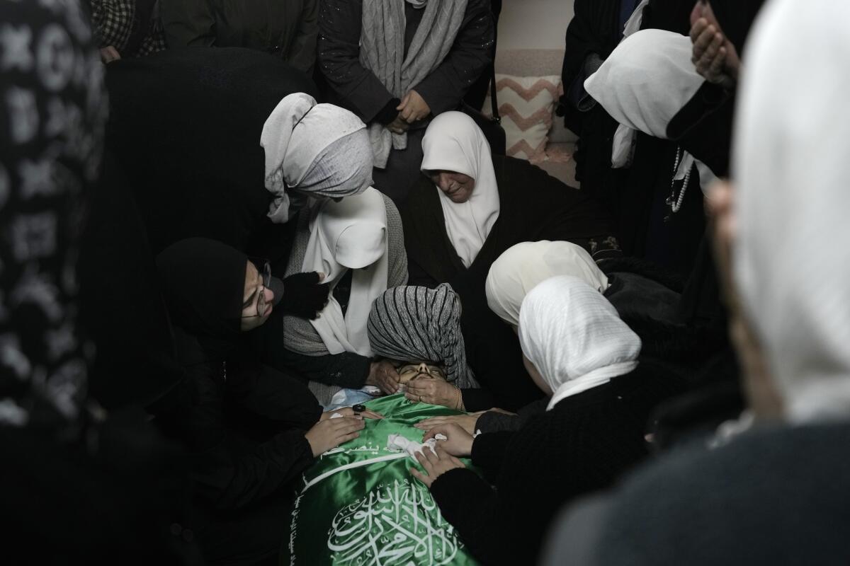 Women gathering around body of slain Palestinian militant
