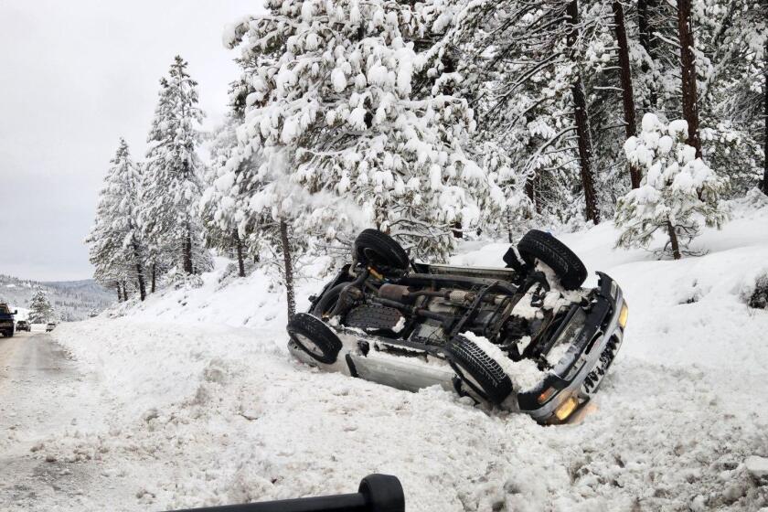A flipped car in Truckee, Calif., on Jan. 11, 2023. As a string of storms hits California, the National Weather Service is warning against travel in the Lake Tahoe area.