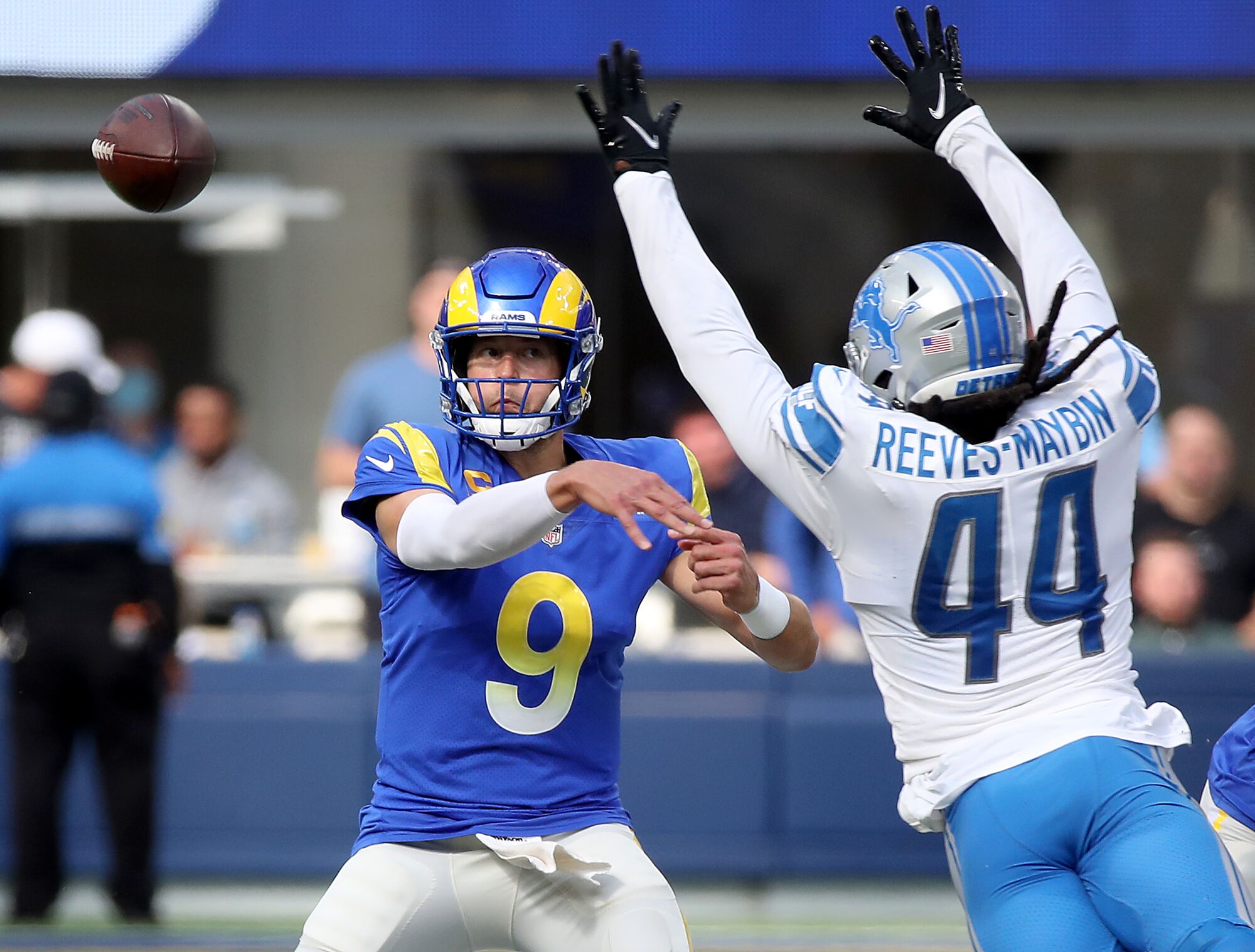 Rams quarterback Matt Stafford unloads a pass while under pressure from Lions linebacker Jaylen Reeves-Maybin.