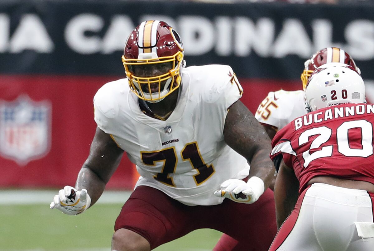 FILE - In this Sept. 9, 2018, file photo, Washington Redskins offensive tackle Trent Williams (71) crouches during an NFL football game against the Arizona Cardinals in Glendale, Ariz. After years of playing in a dysfunctional organization in Washington, the difference in the vibe of a winning franchise hit Williams as soon as he walked into the building for the San Francisco 49ers' training camp. (AP Photo/Rick Scuteri, File)
