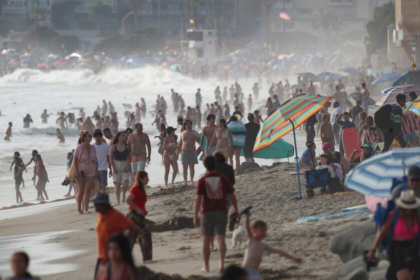 The Laguna Beach coastline looking north to Main Beach Park from Brooks St. shows the wall-to-wall crowds that was typical over the Fourth-of-July weekend. Laguna Beach marine safety department executed more than 2,000 rescues in the high surf, and high tides during the four-day holiday weekend.