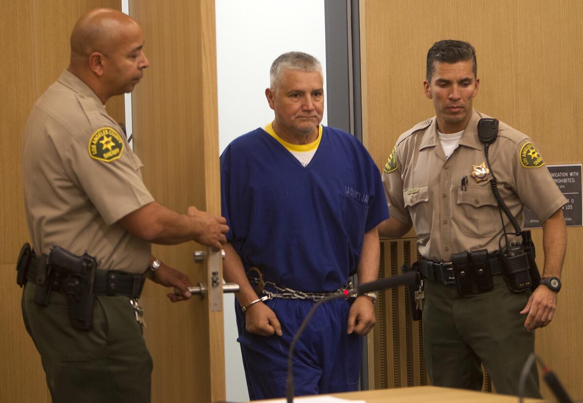 Sheriff deputies escort former LAUSD teacher Robert Pimentel into the courtroom, where he was sentenced to 12 years in prison for molesting students at George de la Torre Jr. Elementary School.