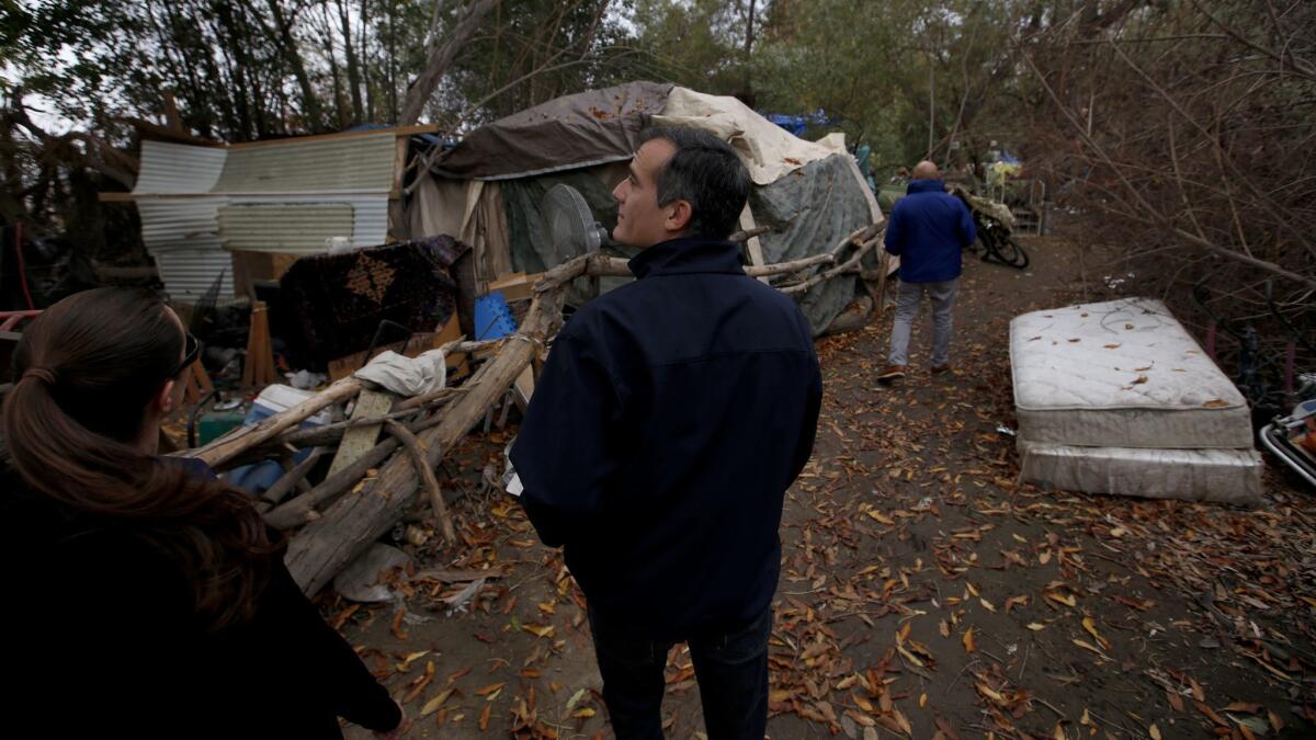 Mayor Eric Garcetti talks with homeless Angelenos at an encampment around the Sepulveda Basin in Encino on Dec. 15, 2016 For L.A. voters, homelessness has eclipsed crime, traffic and schools as the top concern, according to private polls.