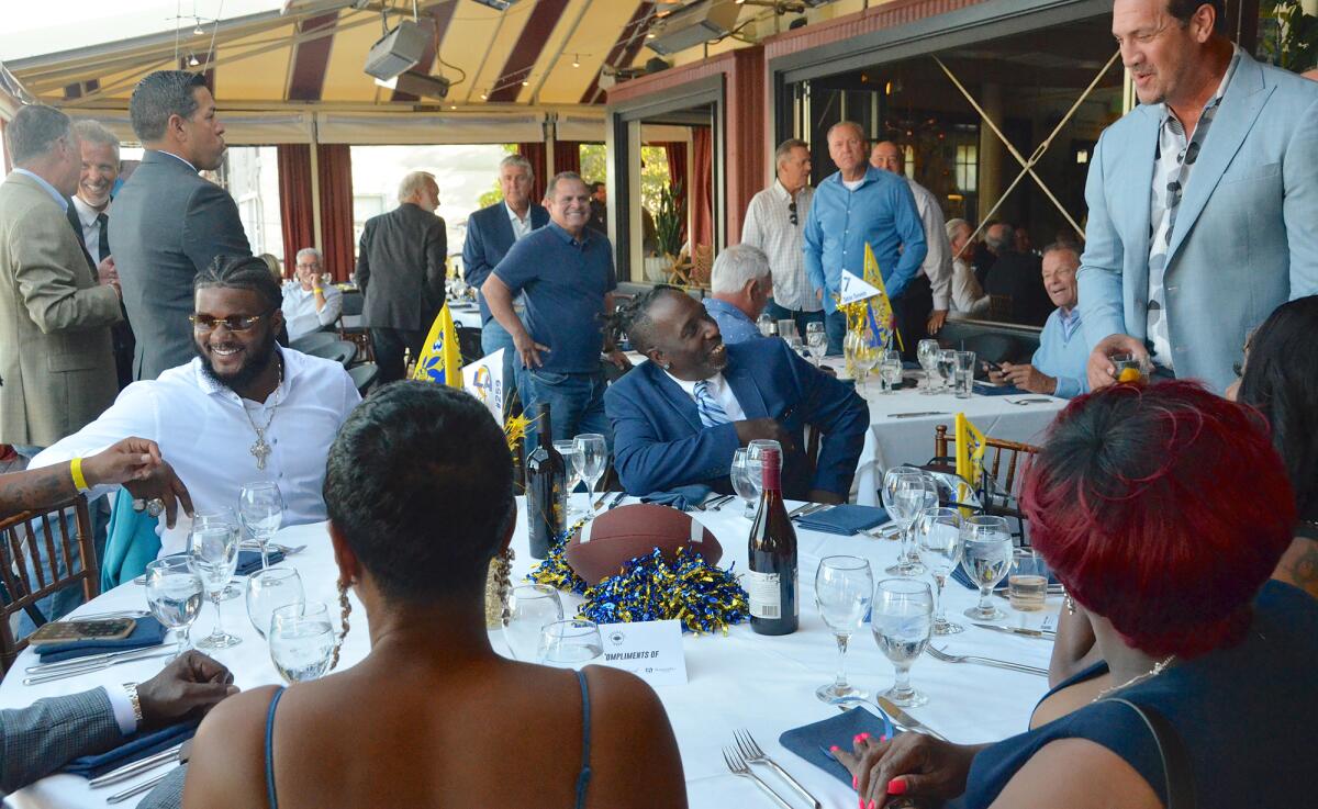 Mr. Irrelevant Desjuan Johnson, far left, chats with guests at the Lowsman Banquet in Newport Beach on Monday.