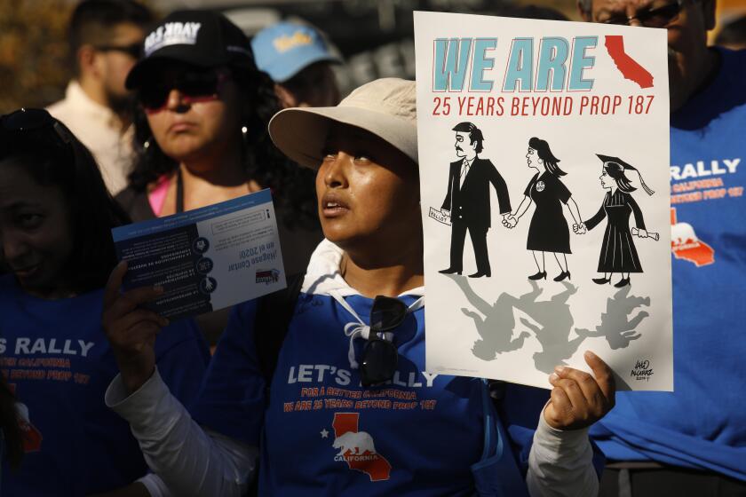 LOS ANGELES, CA - NOVEMBER 9, 2019 - - Maria Campos holds up a sign that reads, “We Are California,” while listening to speakers at the, “Rally for Justice Immigrant Rights and Equality - 25 years beyond Proposition 187,” at the Los Angeles State Historic Park in Los Angeles on November 9, 2019. Prop. 187 aimed to block undocumented immigrants from using non-emergency health care, public education and other services in the State of California. Federal courts denied it from ever being implemented. State Senator Maria Elena Durazo, U.S. Congresswoman Lucille Roybal Allard, Los Angeles Mayor Eric Garcetti, and many members of Los Angeles City Council spoke at the rally. (Genaro Molina / Los Angeles Times)