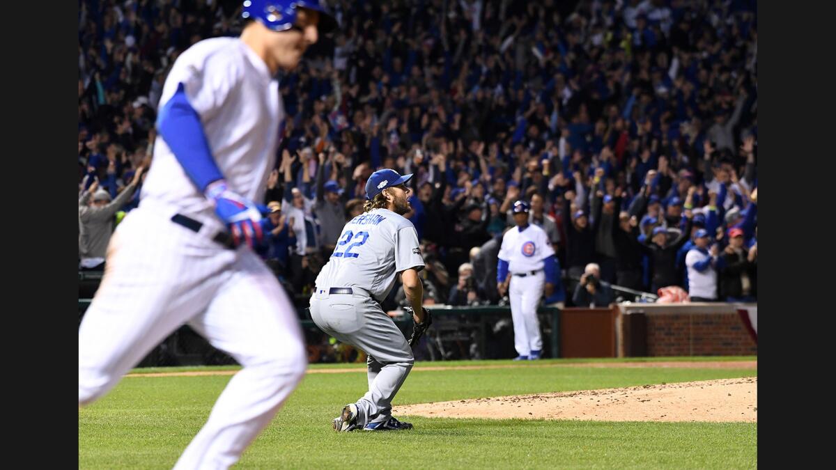 Dodgers pitcher Clayton Kershaw drops to the ground while giving up a home run to Cubs first baseman Anthony Rizzo in the fifth inning of Game 6.
