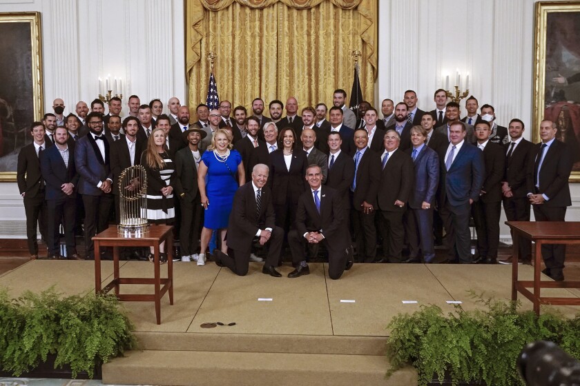 President Joe Biden, Los Angeles Mayor Eric Garcetti and Vice President Kamala Harris pose with Dodgers players and staff.