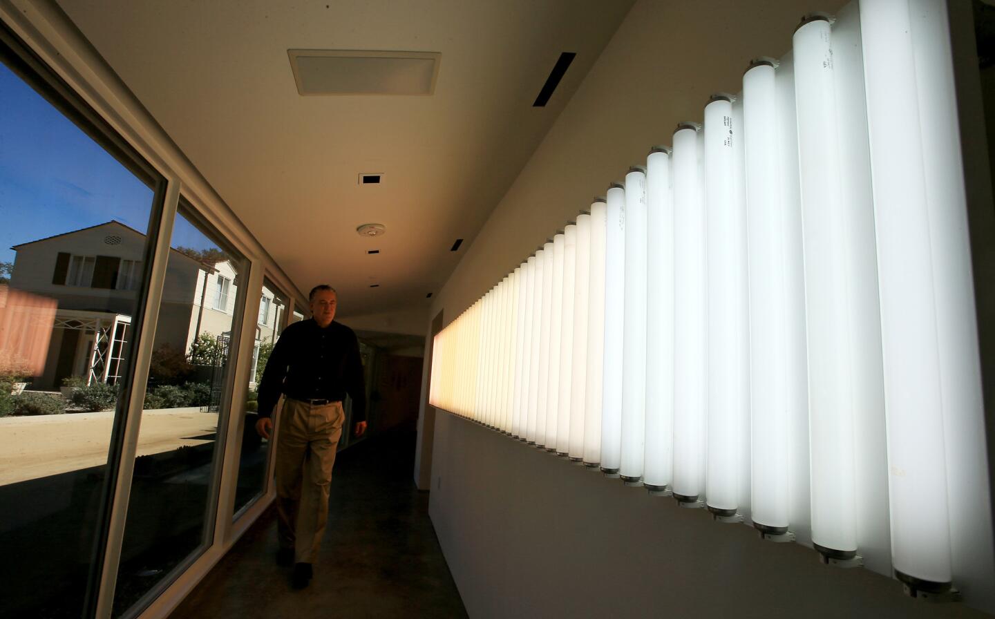 Picture windows in the Stuart Haaga Gallery at Descanso Gardens invite visitors to make connections between indoors and out. Heather Carson's "light/VERTICAL" is part of the current installation of light sculptures.