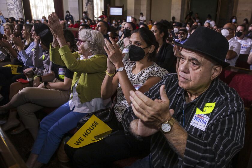 Los Angeles, CA - October 04: Landlords Ben Halfon, right, Monica Kulkarni and Susan Spinks applaud The Los Angeles City Council voting to end the long-standing renter eviction protections due to COVID-19 by February 2024. Tuesday, Oct. 4, 2022 in Los Angeles, CA. (Irfan Khan / Los Angeles Times)