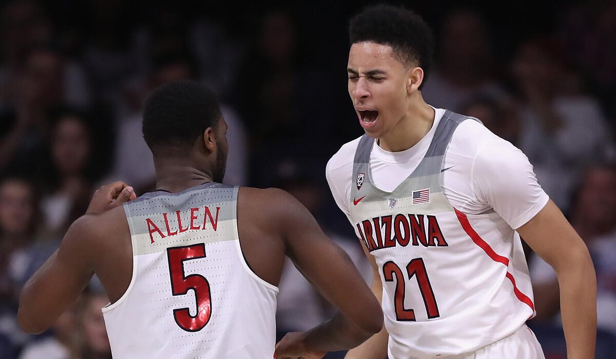 Arizona's Chance Comanche, right, celebrates with teammate Kadeem Allen after scoring against New Mexico during the second half Tuesday.