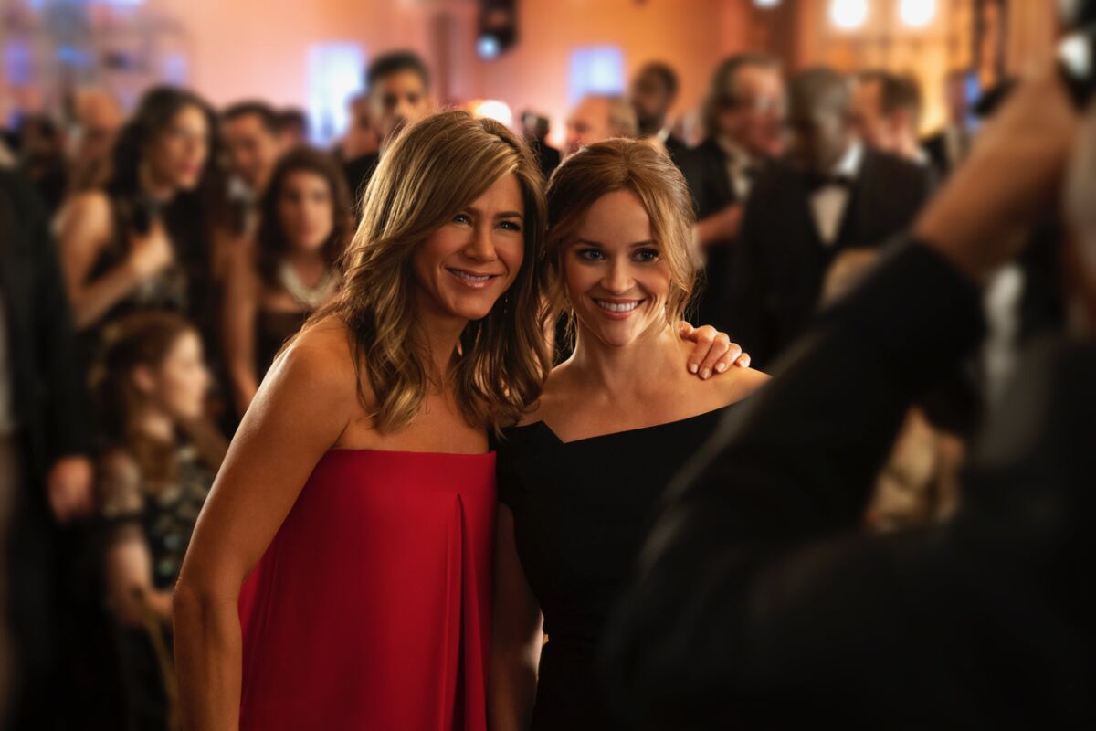 Jennifer Aniston, left, and Reese Witherspoon in "The Morning Show" on Apple TV+.