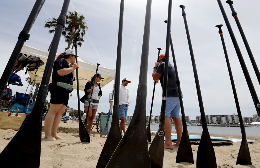 Students take beginner's classes with Tim Sanford, right, from Paddle Method: Stand Up Paddle Board LA in Marina del Rey.