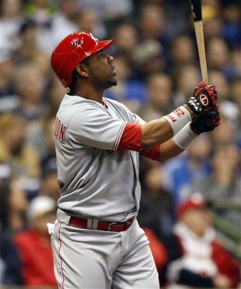 Cincinnati Reds' Edwin Encarnacion watches his grand slam home run sail over the wall against the Milwaukee Brewers during the third inning of a baseball game Monday, April 13, 2009, in Milwaukee. (AP Photo/Jim Prisching)