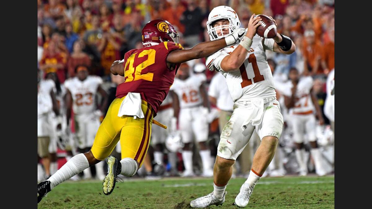 USC linebacker Uchenna Nwosu forces Texas quarterback Sam Ehinger into a bad throw and interception during the fourth quarter last season.