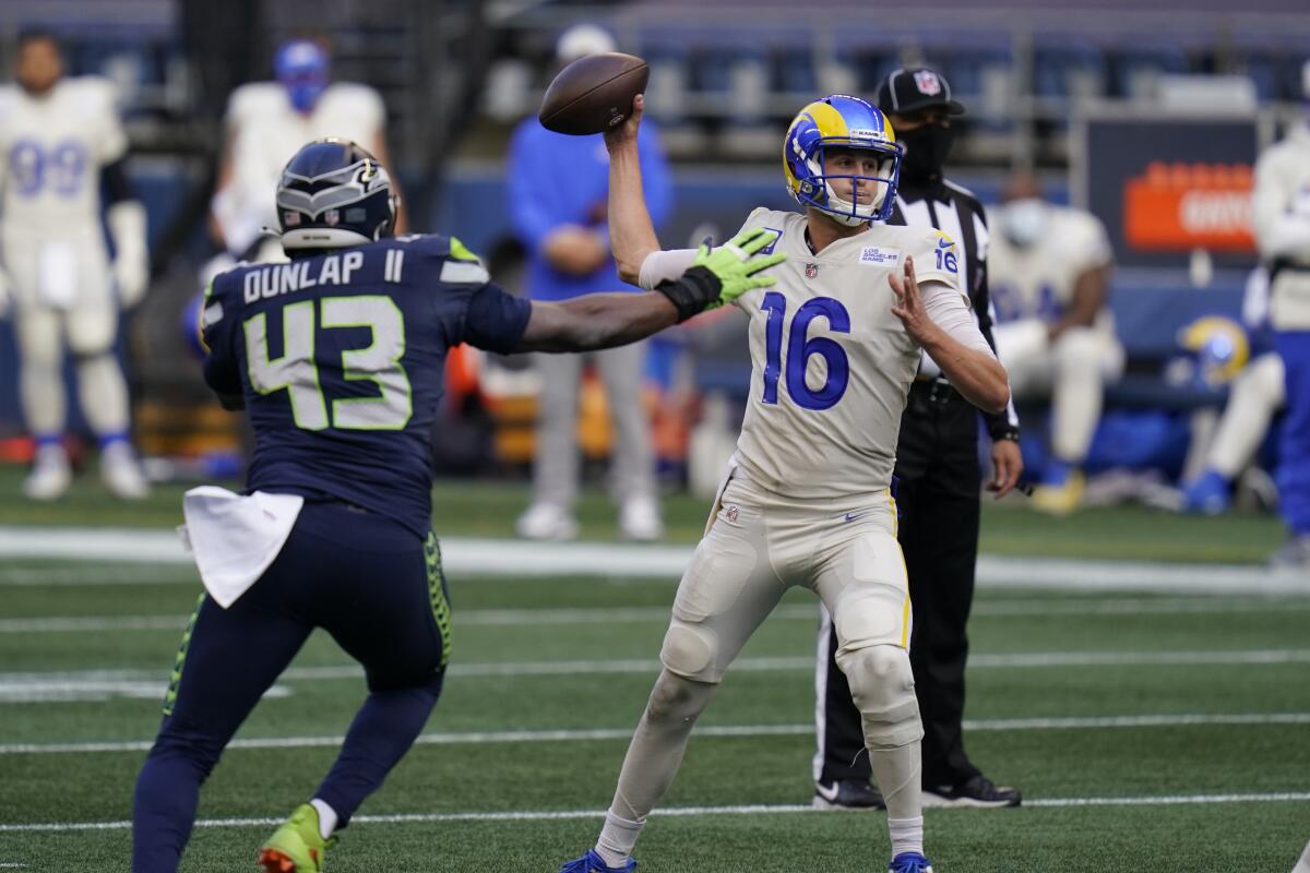Rams quarterback Jared Goff passes under pressure from Seattle Seahawks defensive end Carlos Dunlap.