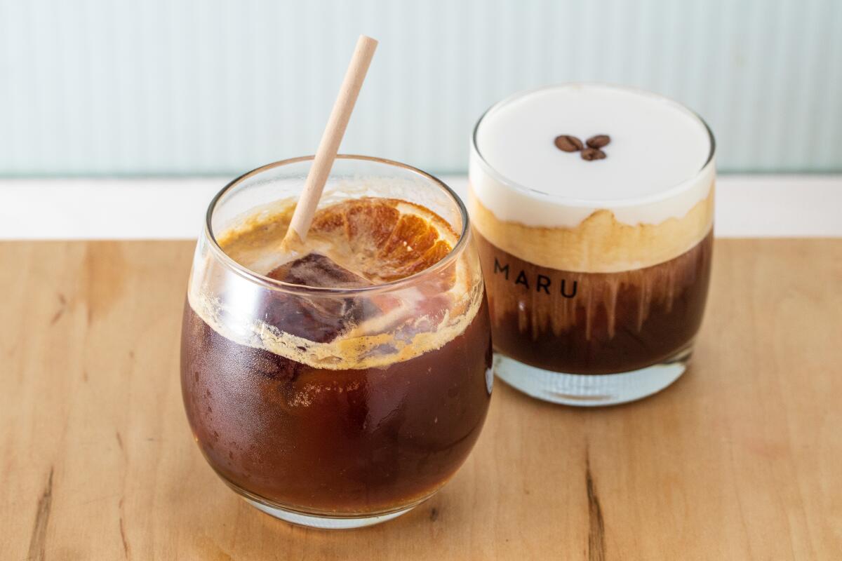 Two clear glasses hold coffee drinks, one with a creamy top, from Maru 