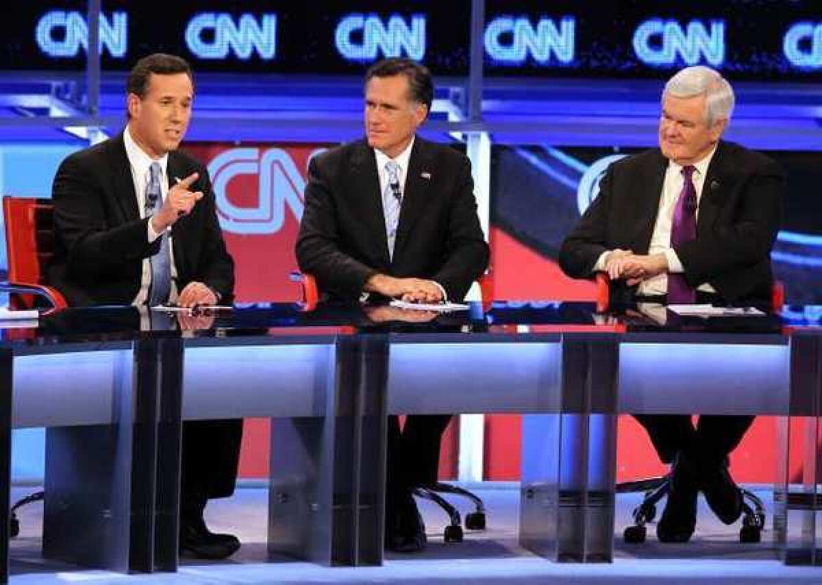 Republican presidential candidates (L-R) Rick Santorum, Mitt Romney and Newt Gingrich participate in a debate sponsored by CNN and the Republican Party of Arizona at the Mesa Arts Center.