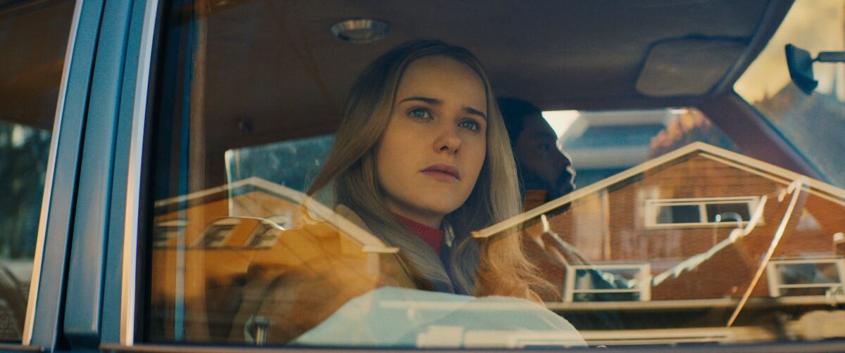 Rachel Brosnahan looks out through a car window in the movie "I'm Your Woman."