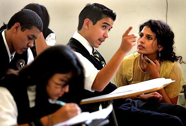 Freshman Andrew Moldonado, 13, asks English teacher Maryem Irias a question during class at the Los Angeles International Charter High School in Hermon. The explosive growth of charter schools has challenged the status quo in the L.A. Unified School District.