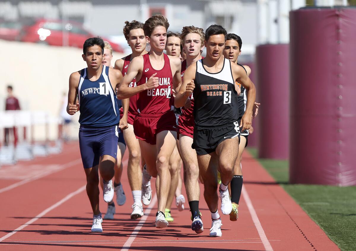 With one lap to go, Newport Harbor High's Alexis Garcia (1), Laguna Beach's Sebastian Fisher (2) and Huntington Beach's Lars Mitchel (3) compete in the boys' 1,600-meter event during the Wave League finals at Laguna Beach on Thursday.