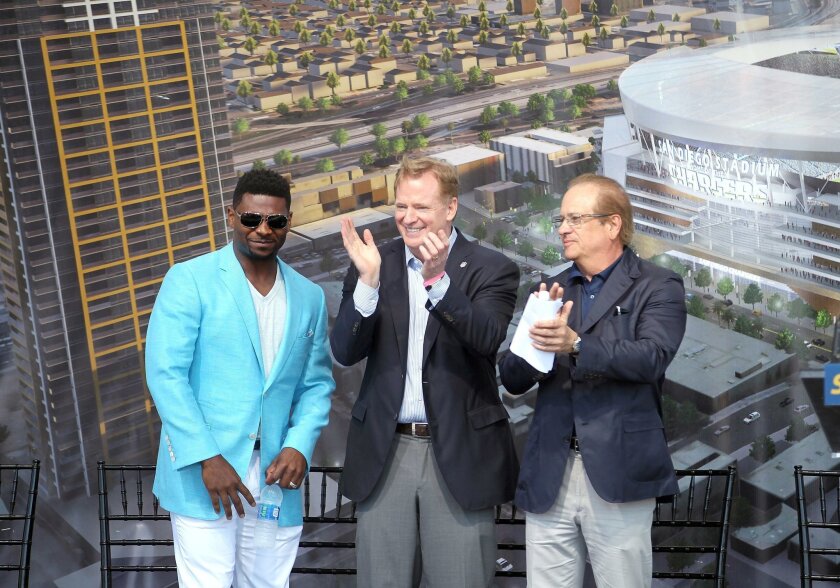 LaDainian Tomlinson, left, NFL commissioner Roger Goodell and Chargers chairman Dean Spanos stand on stage during the Chargers citizens’ initiative rally.