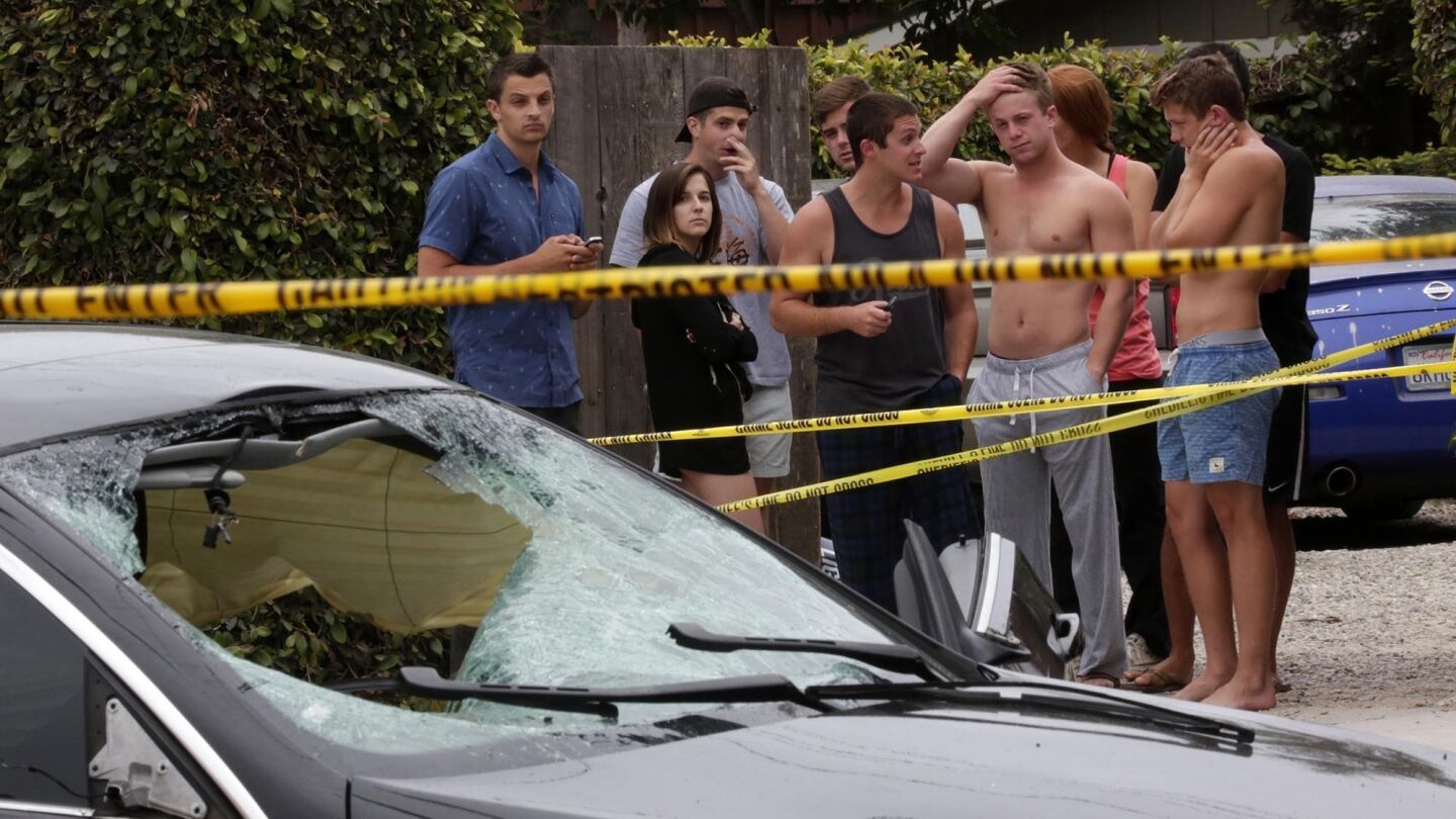 The gunman's car is cordoned off in Isla Vista, where seven people, including the attacker, were killed. He was found slumped in the BMW, three handguns and more than 400 rounds of ammunition at his side.