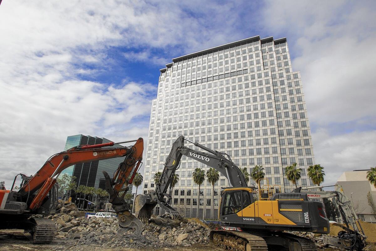 Excavators sit at the site of a new apartment complex at 580 Anton Blvd. in Costa Mesa's South Coast Metro district in 2016.