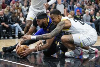 Los Angeles Lakers forward Anthony Davis, left, and Utah Jazz forward John Collins.