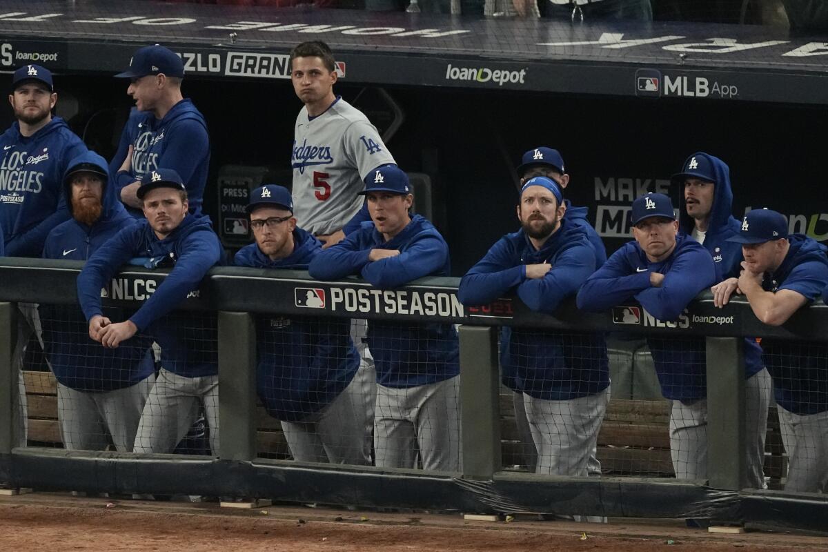 Dodgers players watch from the dugout during the ninth inning of their season-ending loss to the Atlanta Braves.