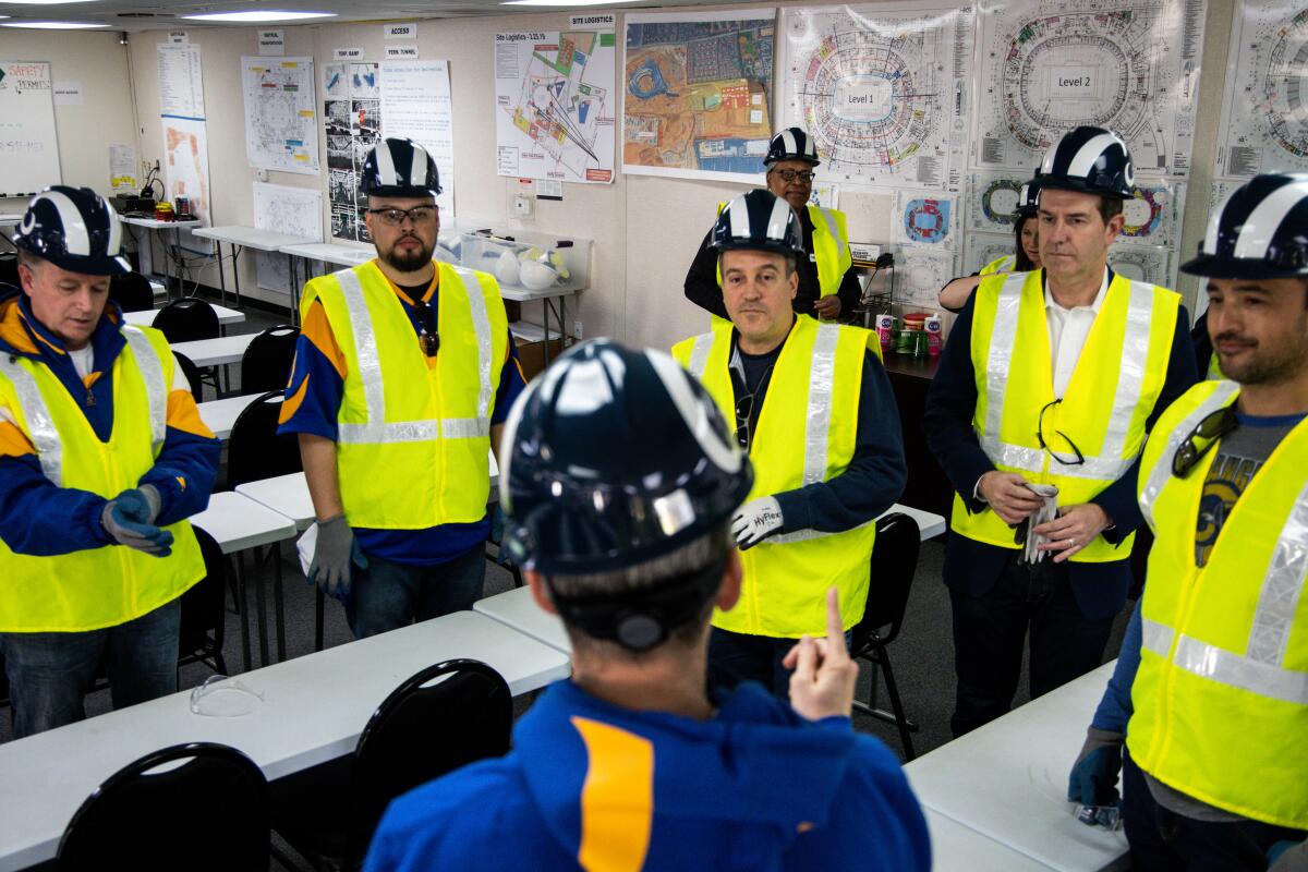 Kevin Demoff, Los Angeles Rams Chief Operating Officer, speaks with members of the Ram’s House Fan Council before going on a tour of SoFi Stadium on Dec. 27.