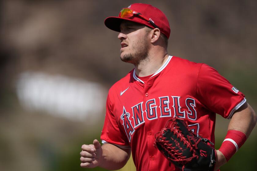 Los Angeles Angels' Mike Trout runs to the dugout during the first inning of a spring training baseball game against the Milwaukee Brewers, Tuesday, Feb. 27, 2024, in Tempe, Ariz. (AP Photo/Matt York)