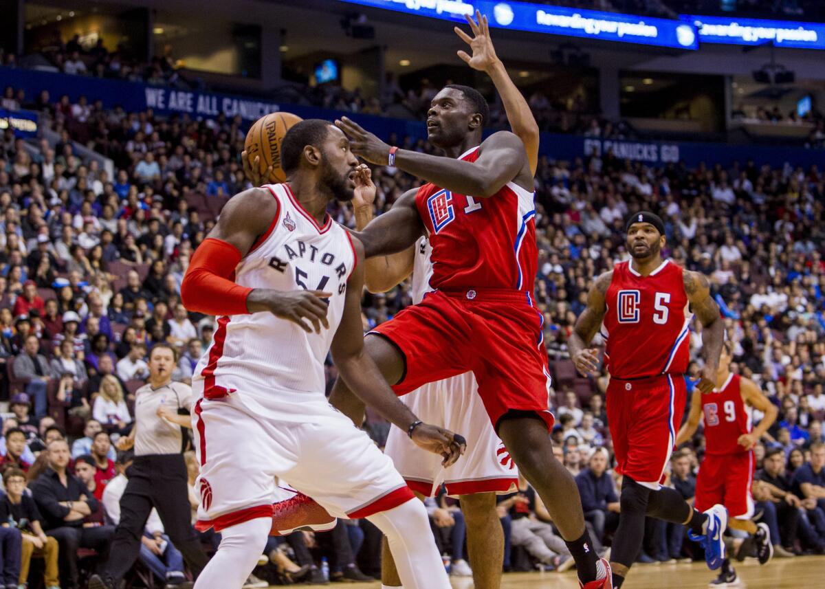 Clippers forward Lance Stephenson (1) goes up for a finger roll attempts over Raptors forward Patrick Patterson.
